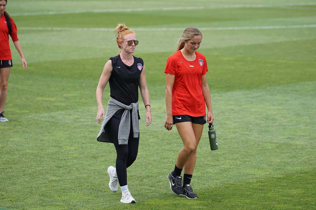 people two woman walking beside each other person