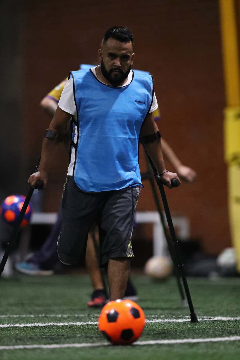 person walking man towards ball team