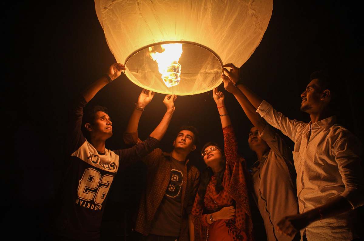 person woman and men holding on a paper lantern bangladesh