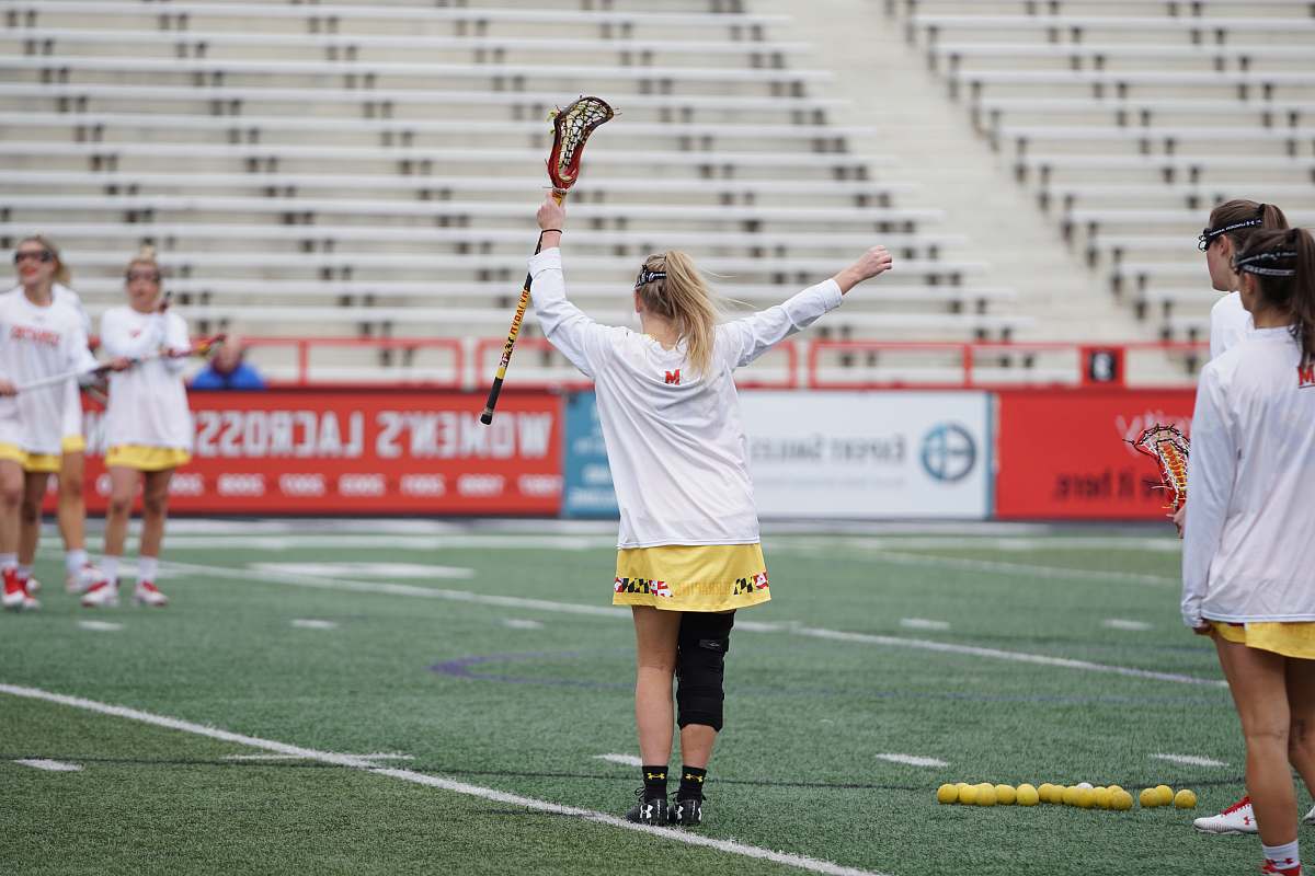 people woman holding lacrosse stick person