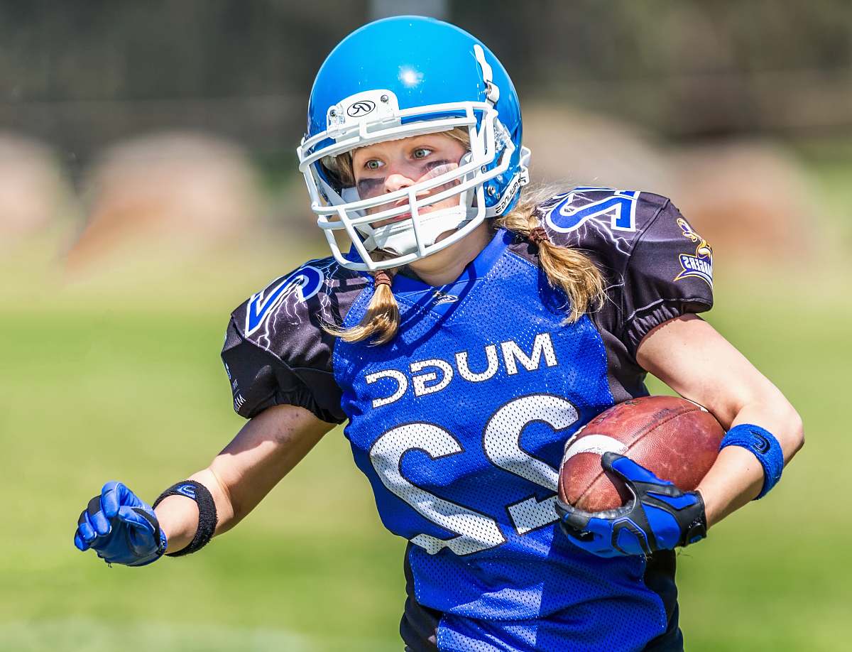 team woman in blue helmet playing football helmet