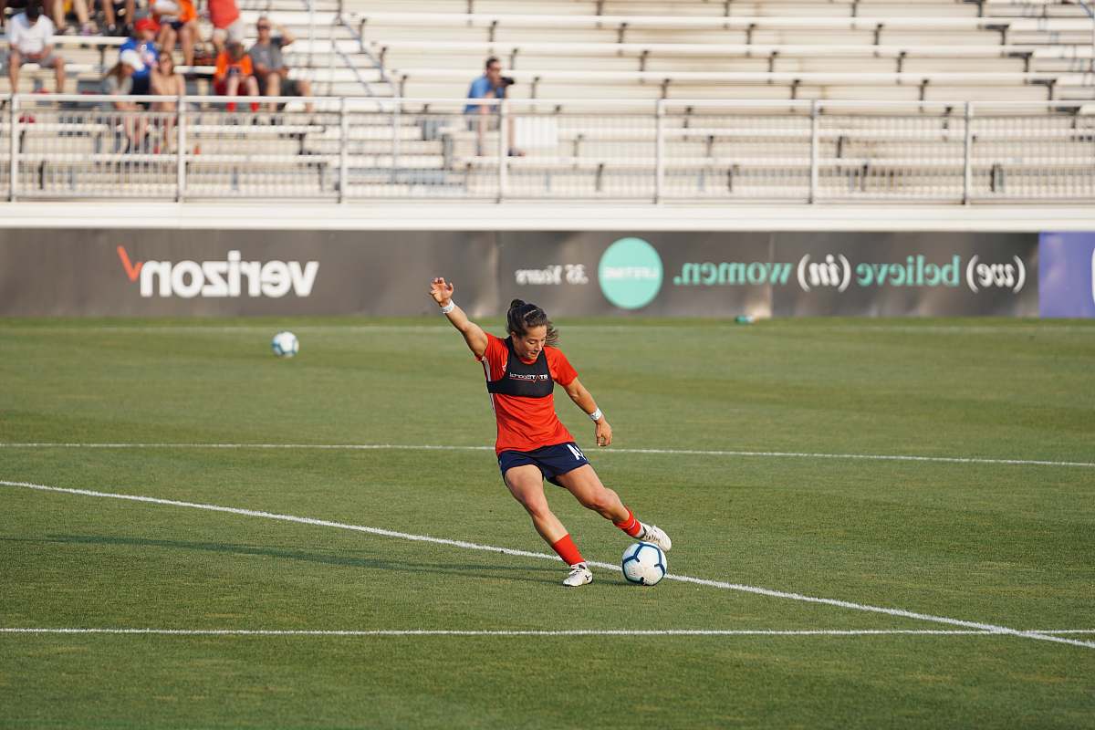 person woman kicking soccer ball people