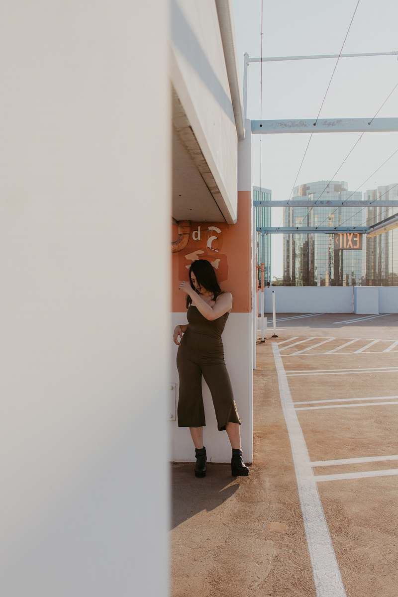 person woman leaning on wall flooring