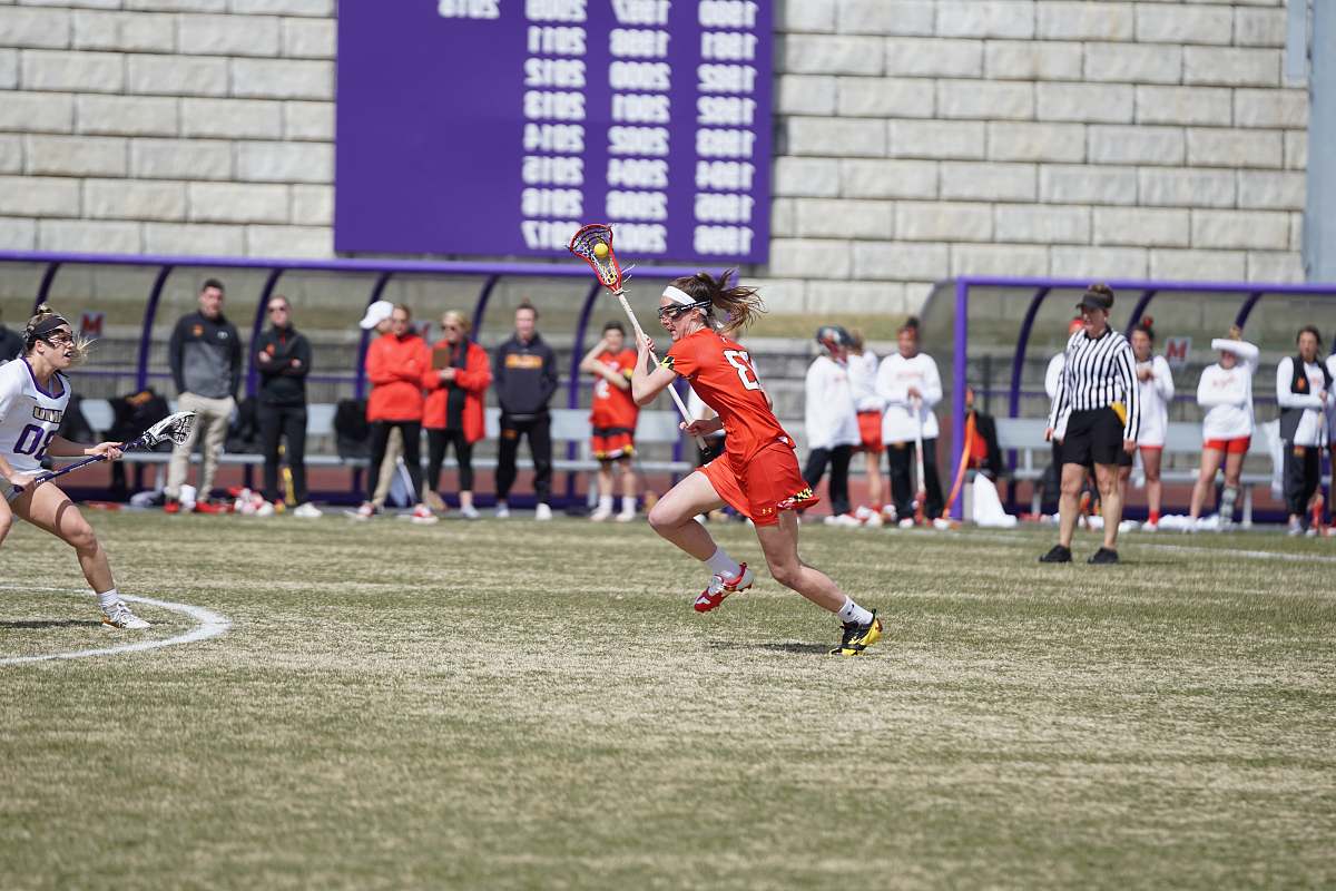 person woman playing lacrosse on the field people
