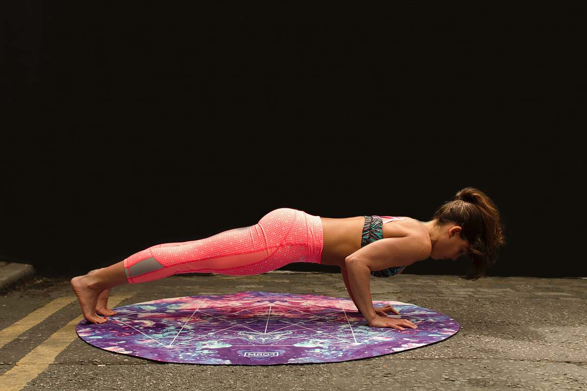 fitness woman pushing up on yoga mat yoga