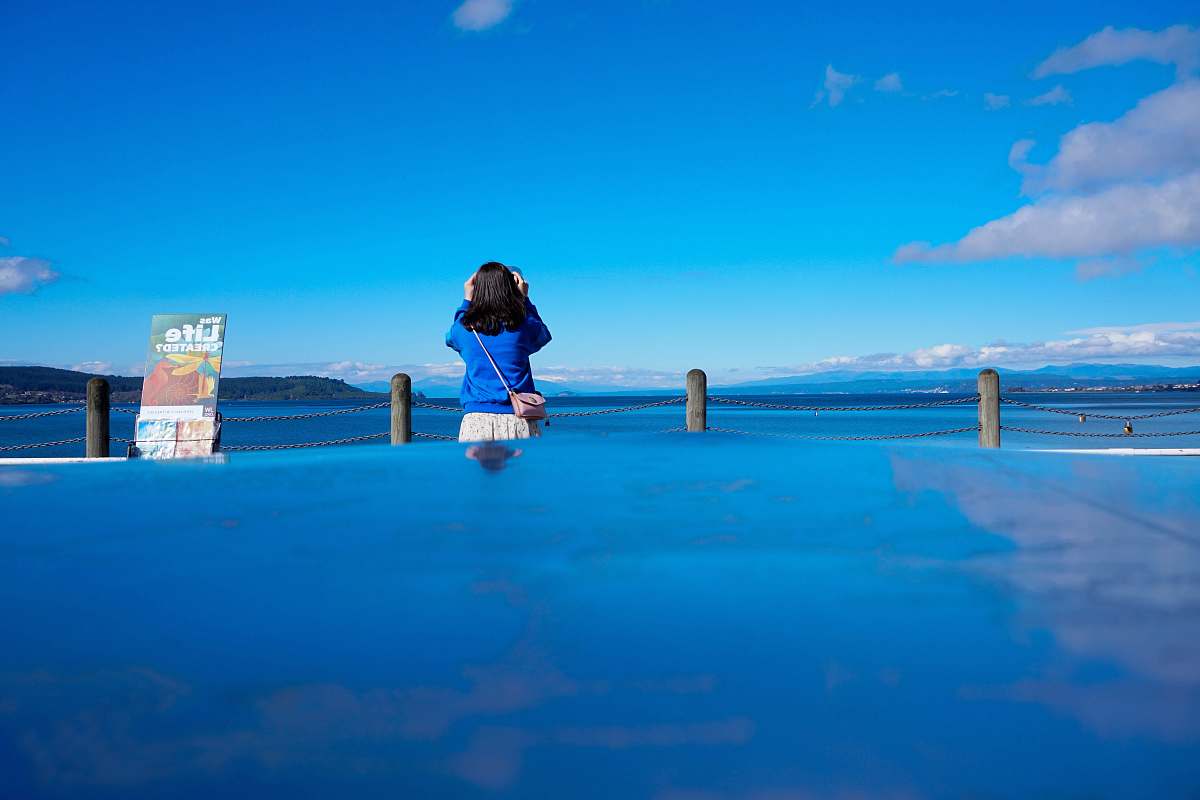 person woman standing beside sea people
