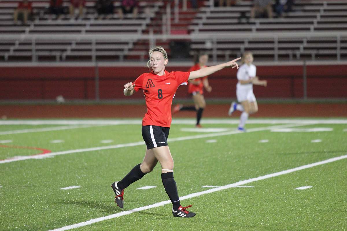 person woman standing on soccer field and people watching them sport