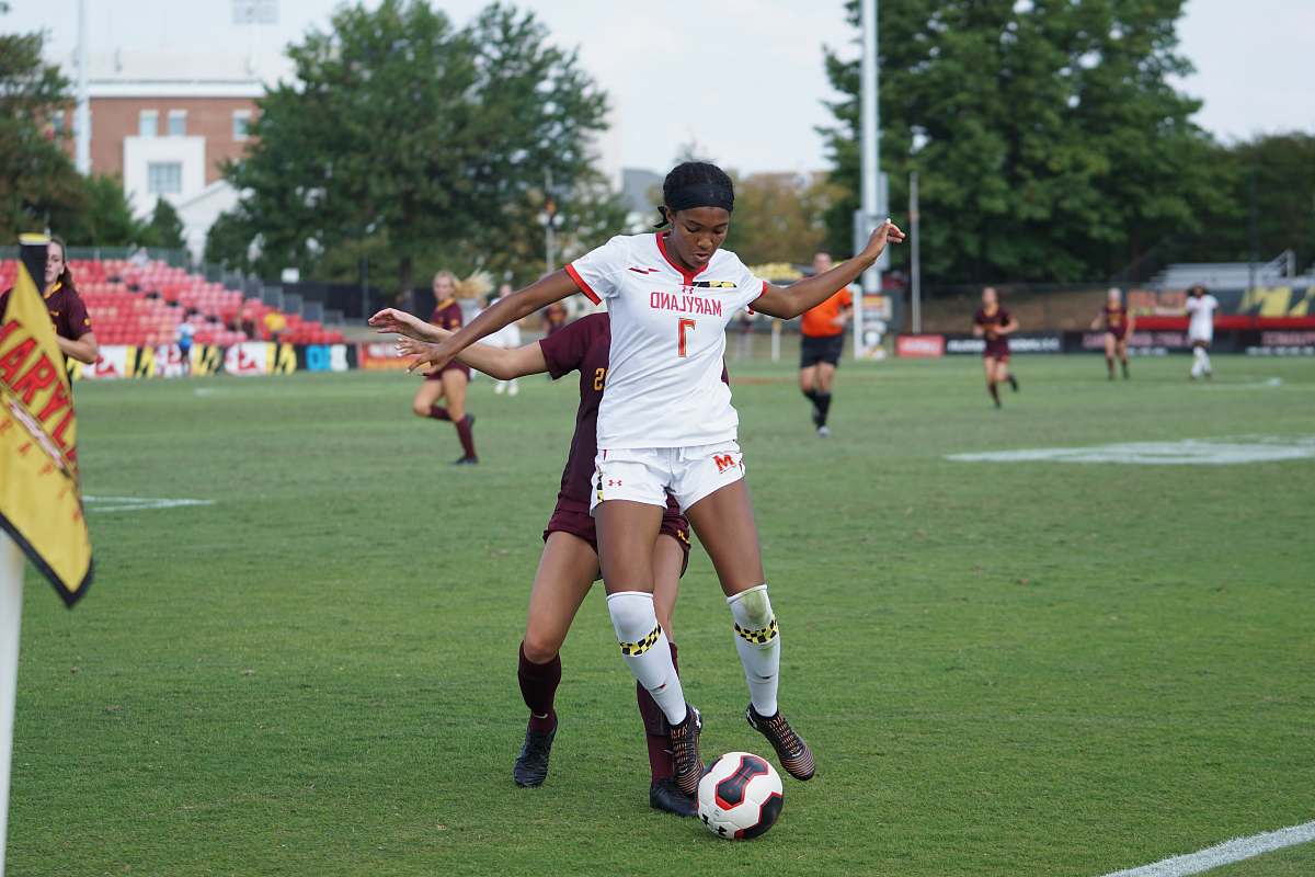 person women playing football on field during daytime people