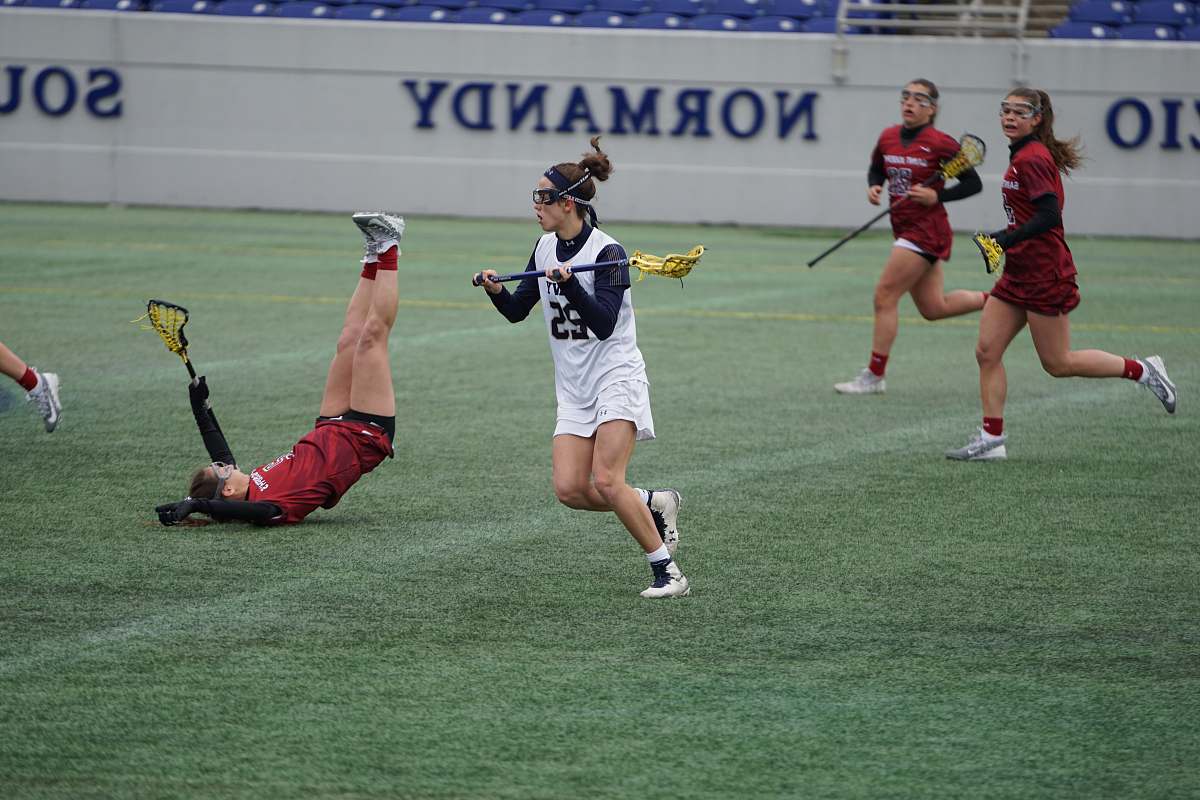 person women playing lacrosse during daytime people