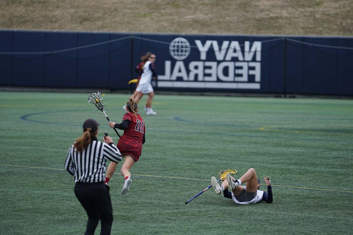 person women playing lacrosse sports hockey