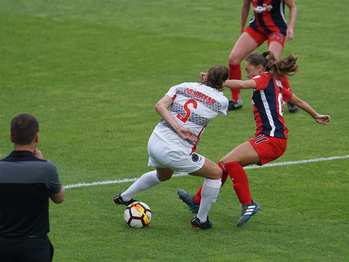 person women playing soccer in an open field people