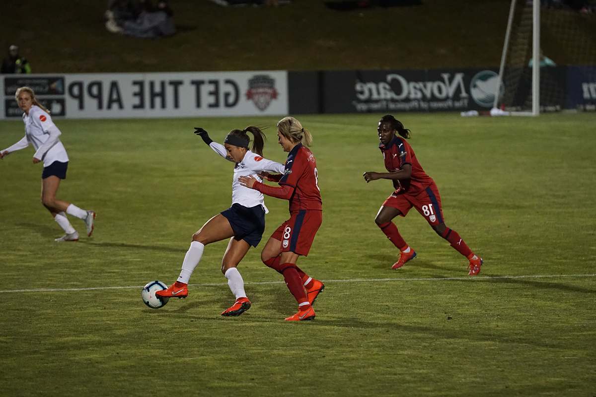 person women playing soccer of grass field people