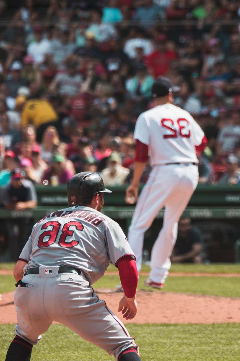 person baseball players playing inside the field during daytime baseball