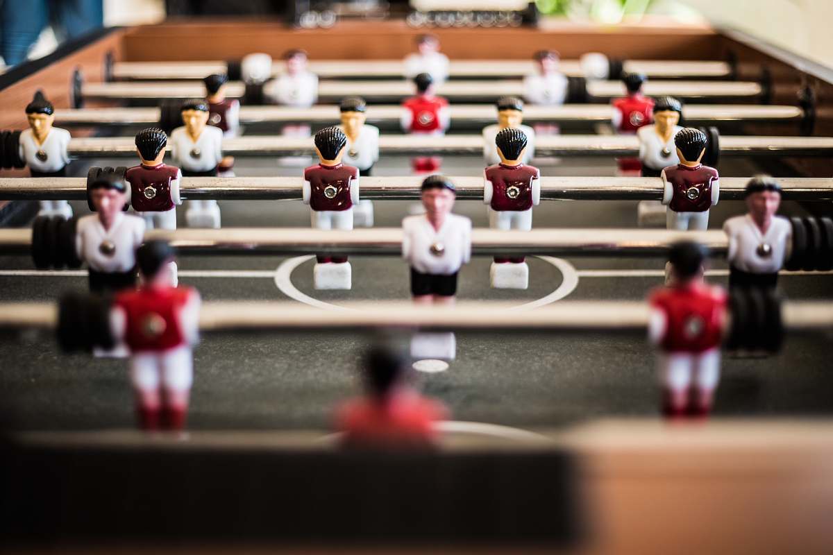 human brown foosball table closeup photography person