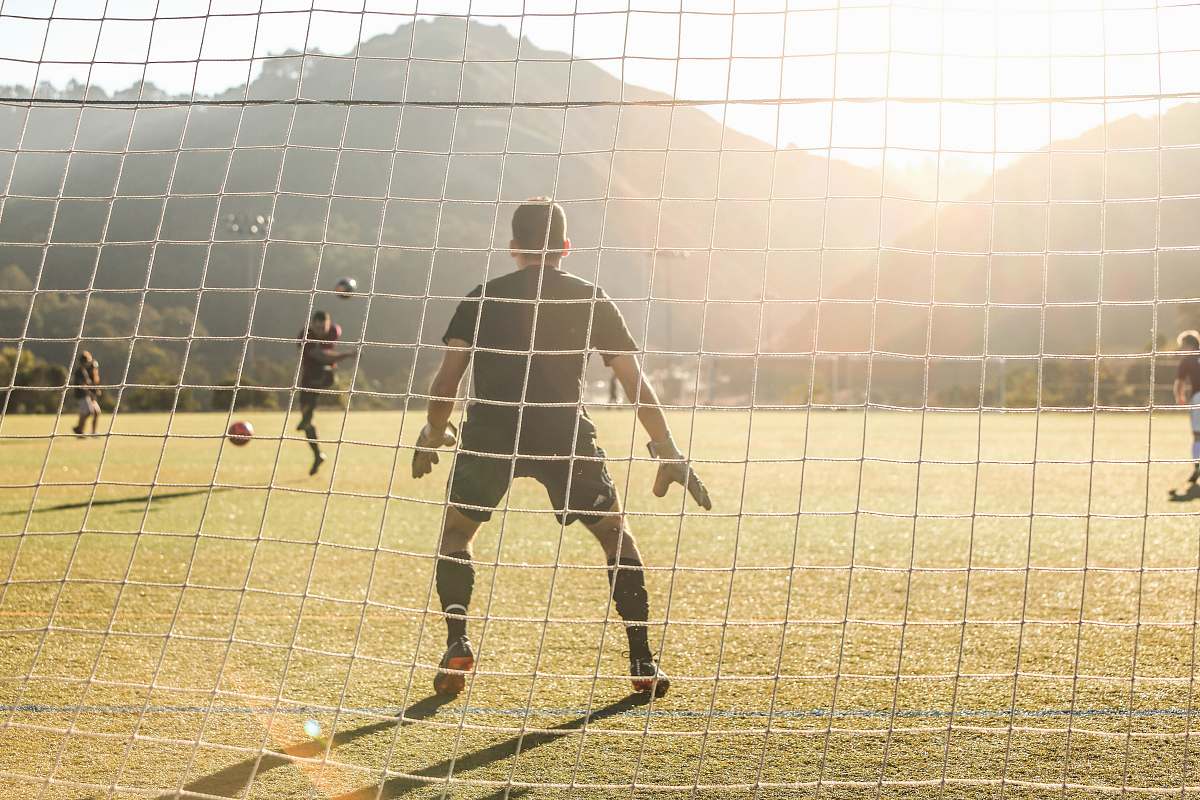 human men playing soccer person