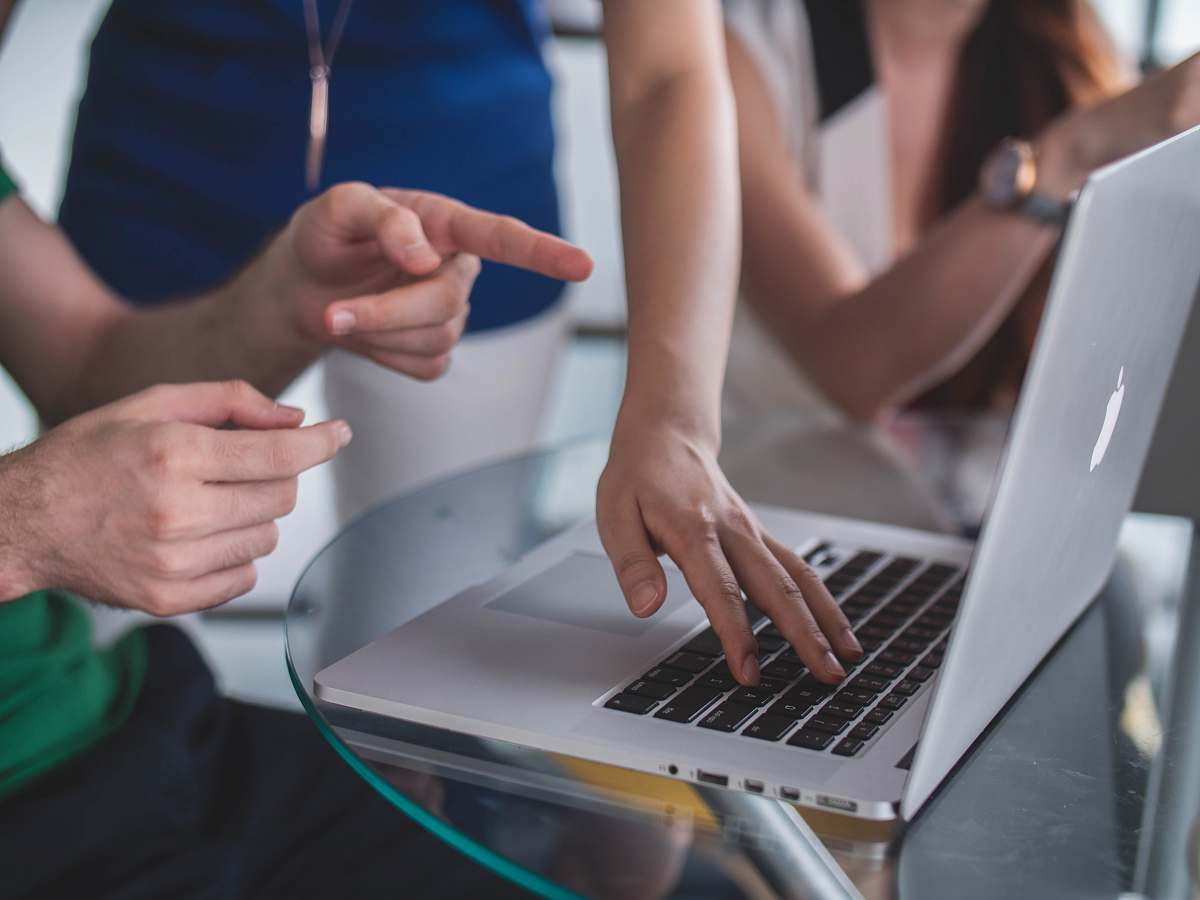 person person touching and pointing MacBook Pro computer