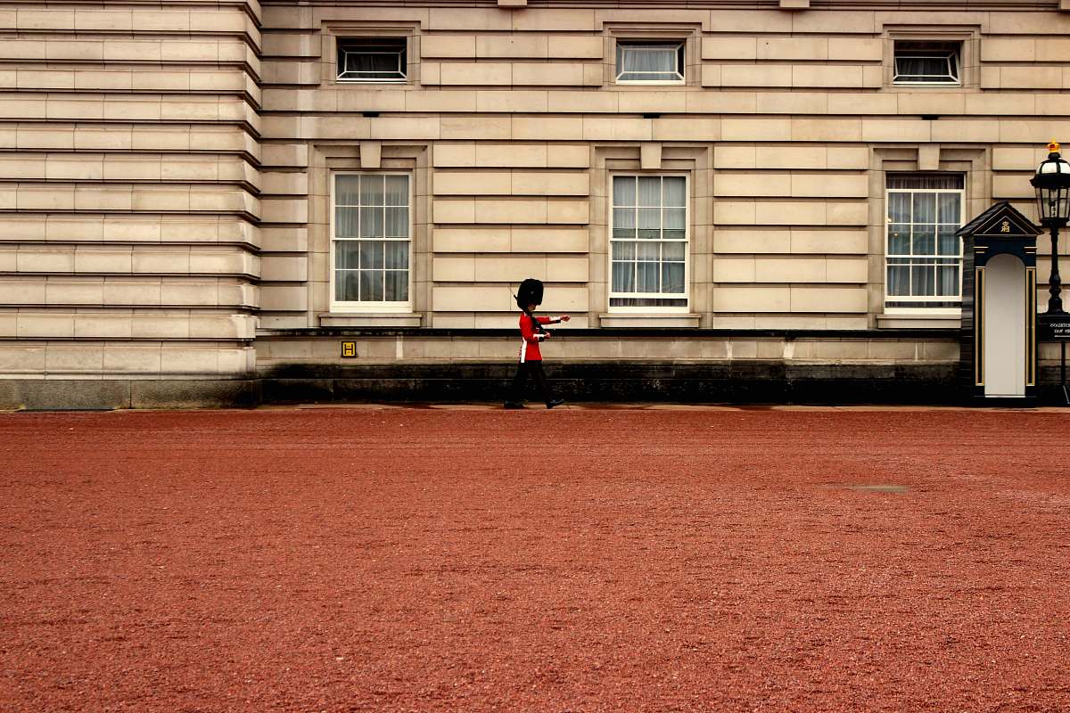 human person walk near the building during daytime person