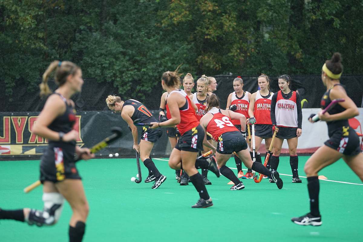 human women playing field hockey person