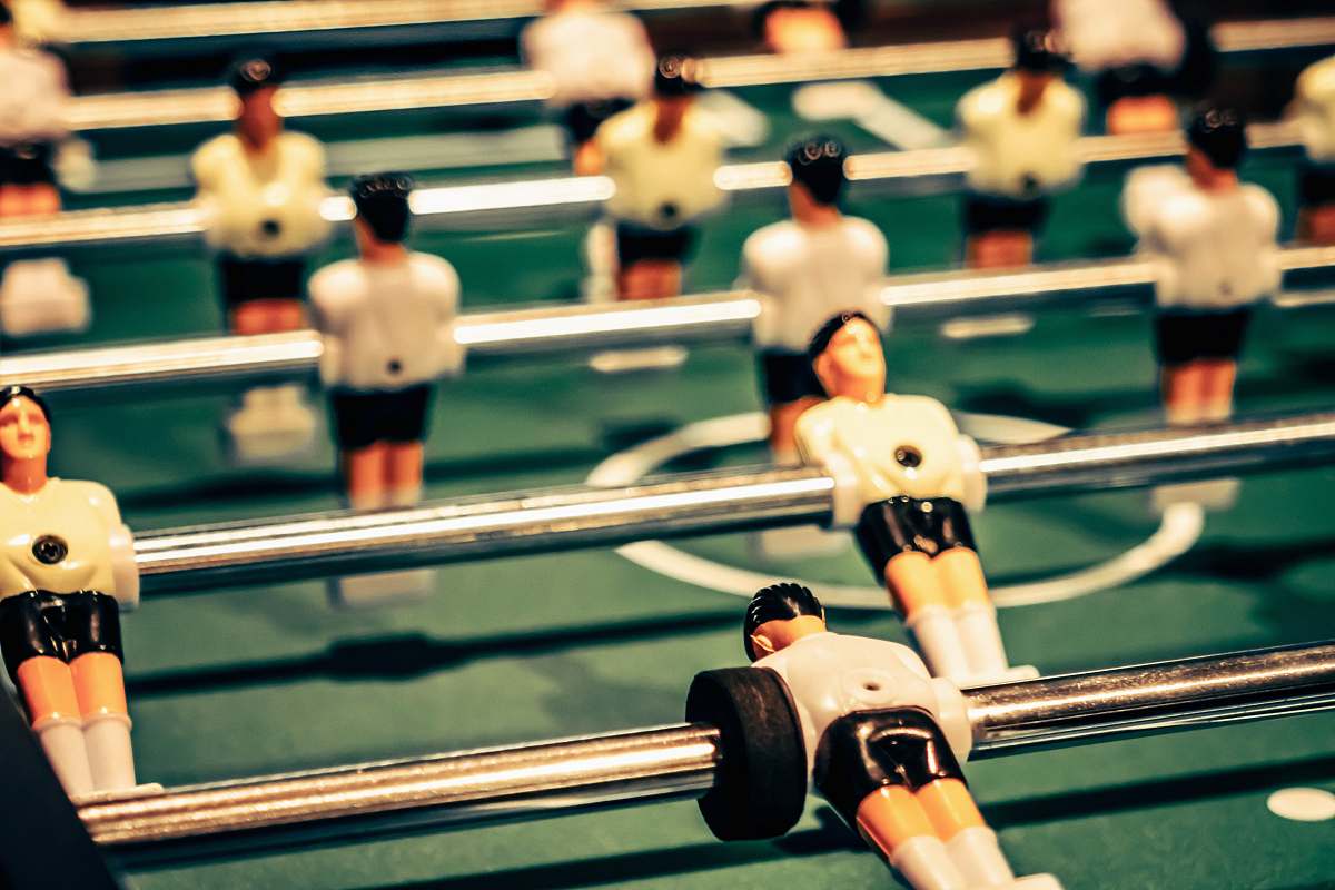 human close up photography of foosball table people