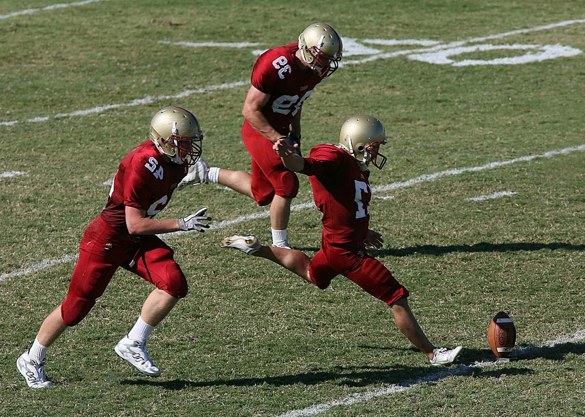 sport football player doing goal kick ball