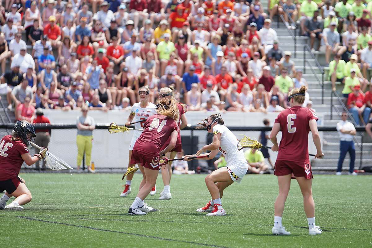 human girl playing lacrosse during daytime people