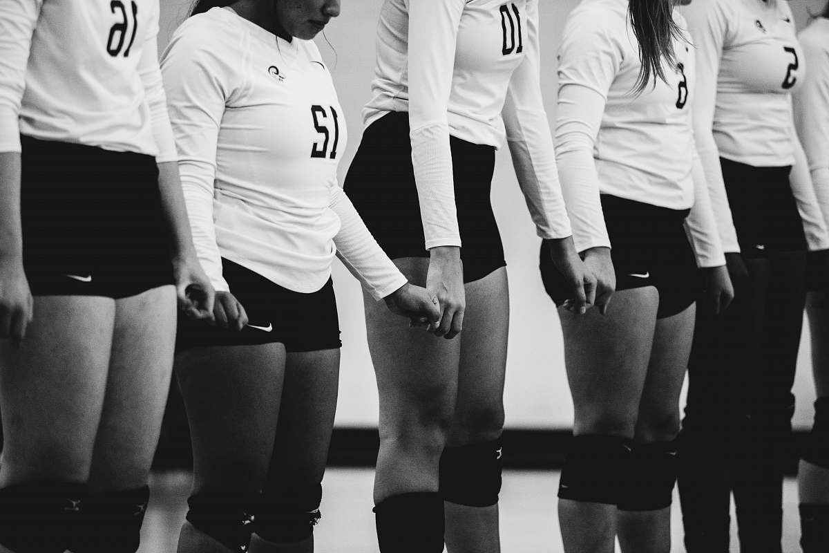 human grayscale photography of women volleyball team lined up together black-and-white