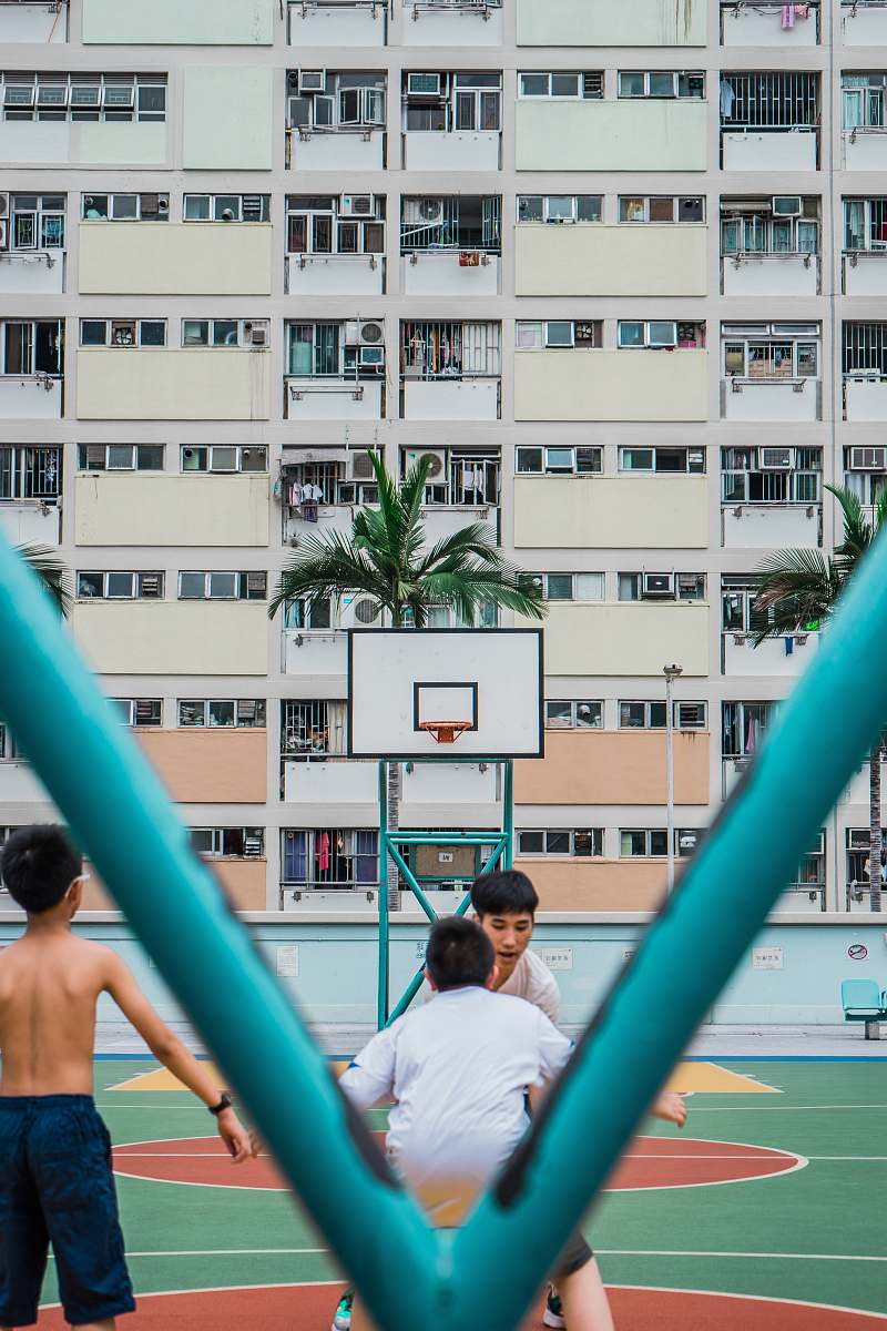 human group of people playing basketball during daytime people