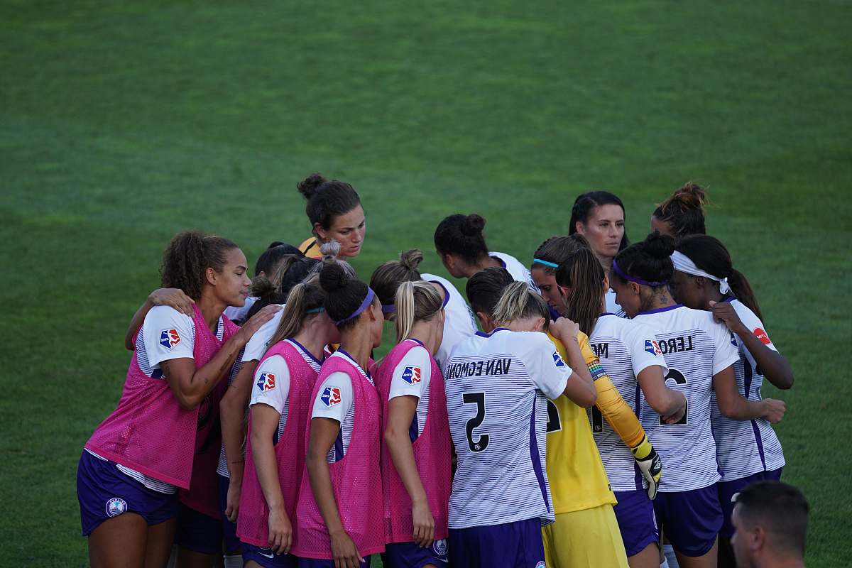 human group of players on field during daytime people
