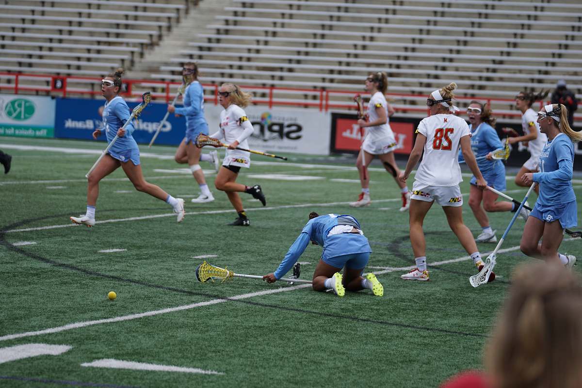 human group of women playing lacrosse during daytime people