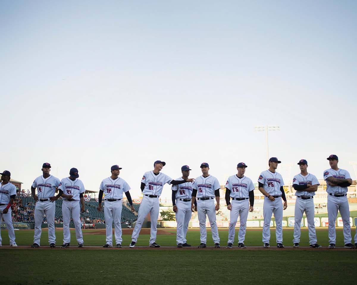 human lined baseball players on field people