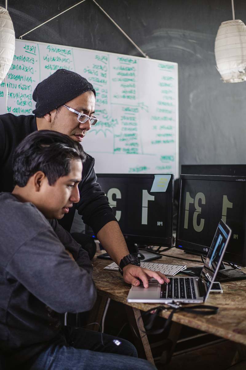 human man sitting in front of laptop computer
