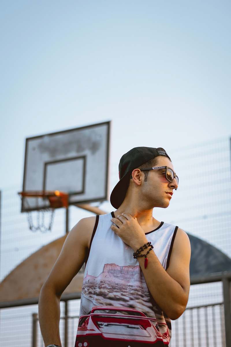 human man wearing white tank top during daytime accessories
