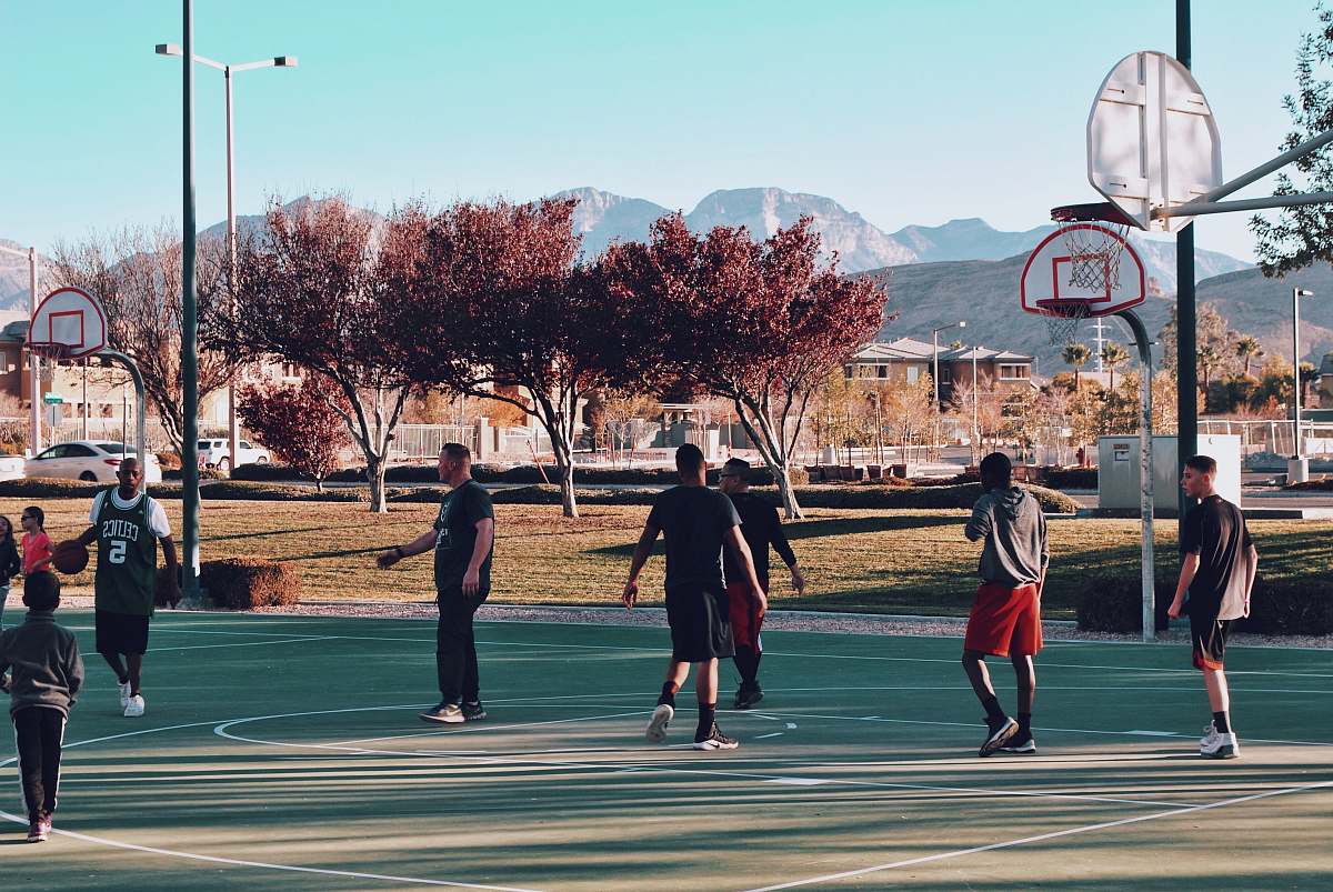 people men playing basketball during daytime human