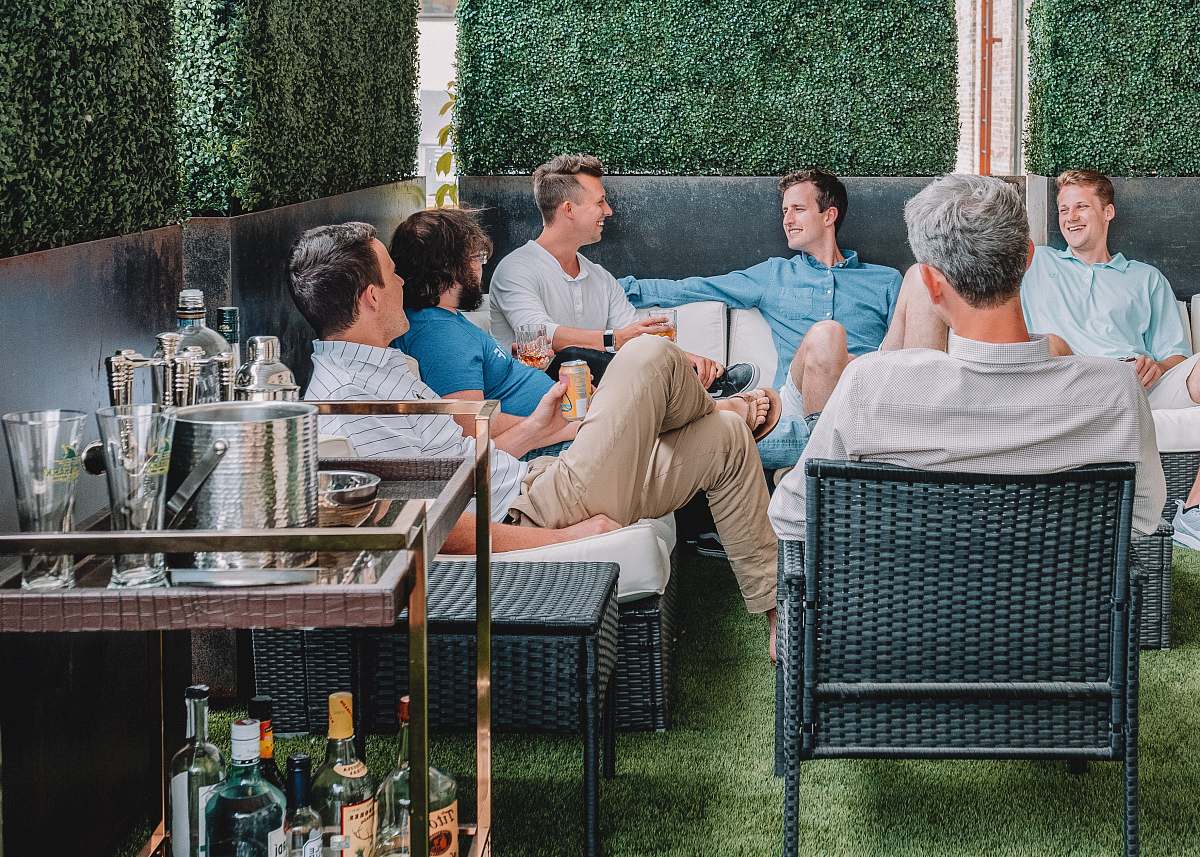 human men sitting on chairs sitting