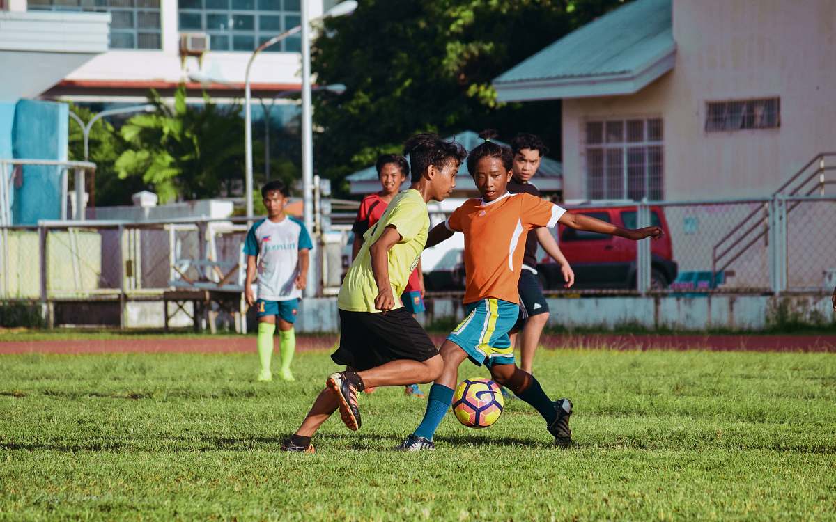 football men's playing soccer during daytime soccer