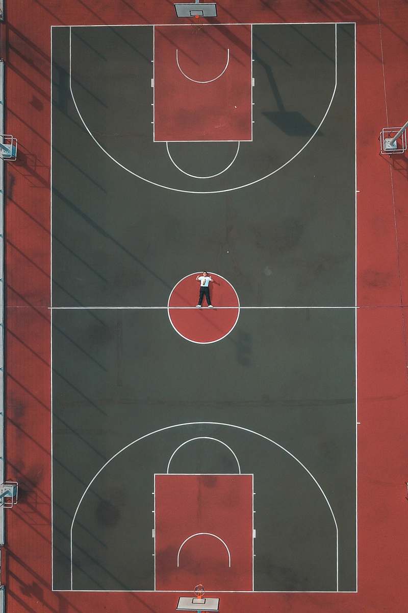 basketball person lying in the middle of basketball court basketball court