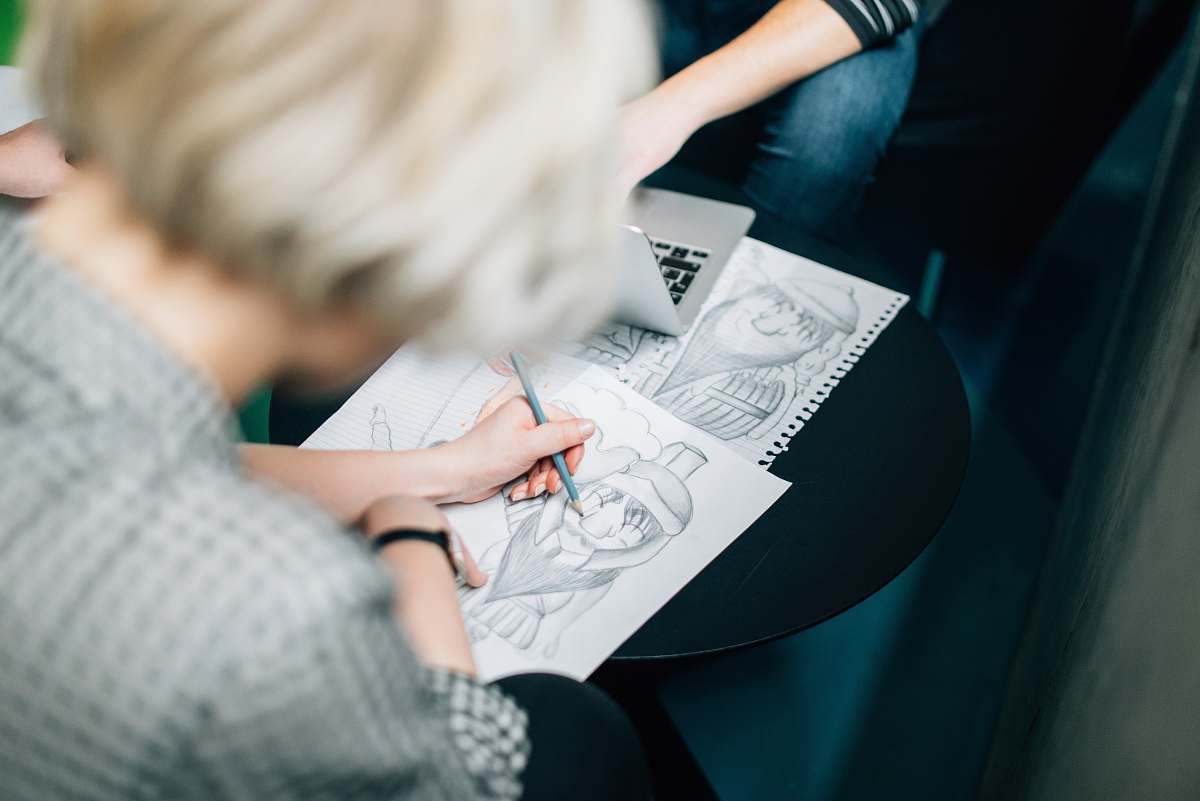 reading person wearing gray shirt sketch working