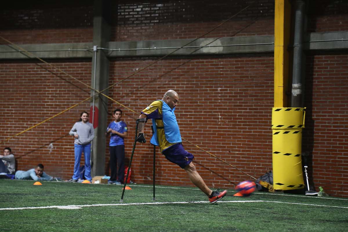 human person with food disability playing soccer people