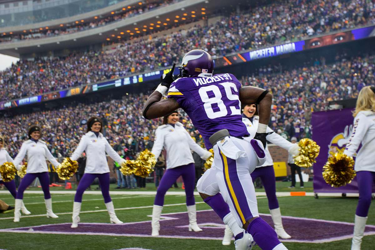 human purple and white Peterson 28 running on stadium people