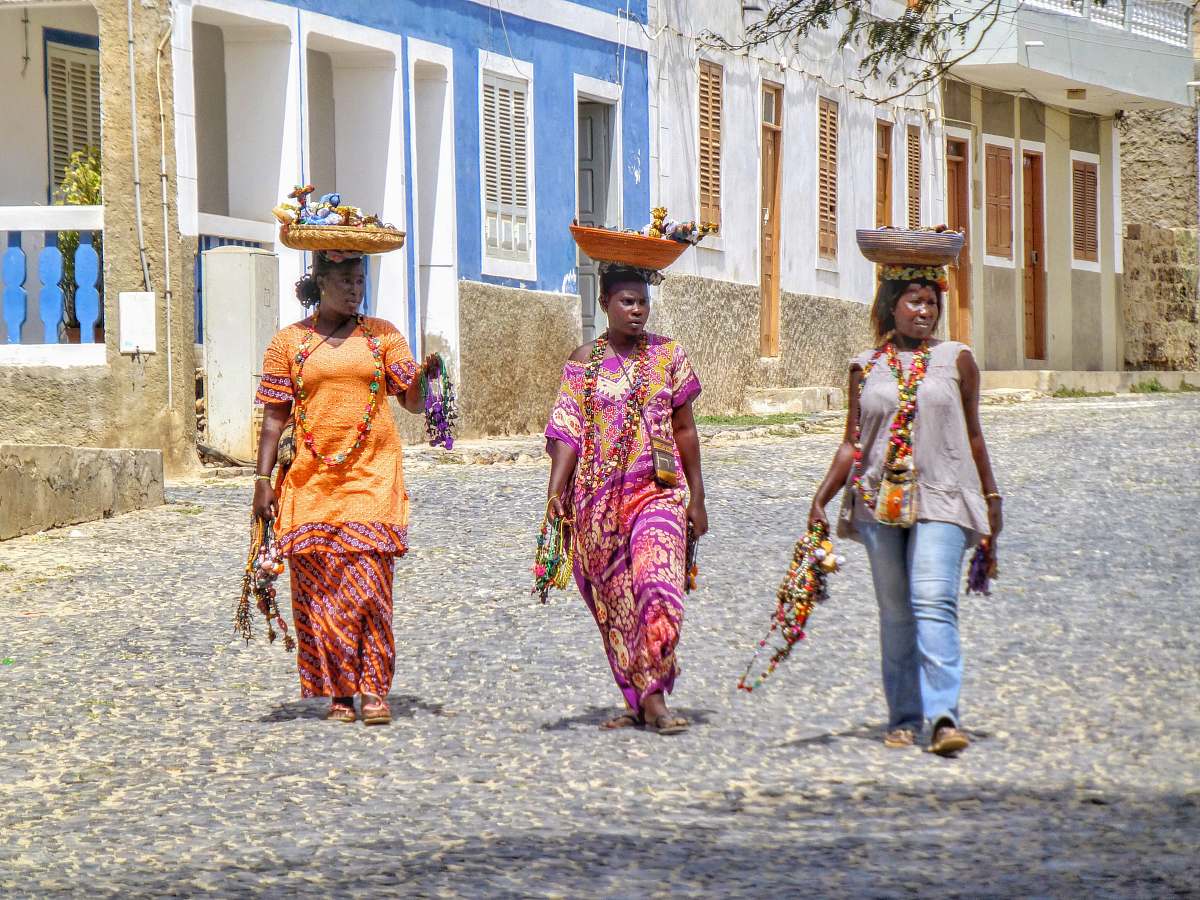 apparel three woman carrying basket over their heads clothing