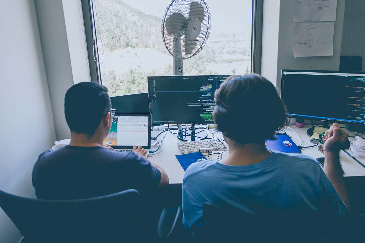 Human Two Men Using Computer And Laptop People Image Free Photo