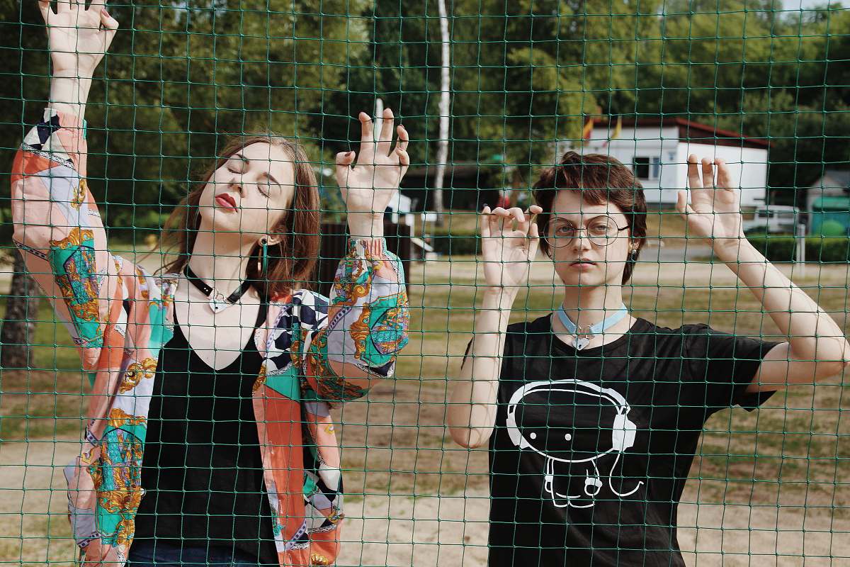 human two women facing net clothing