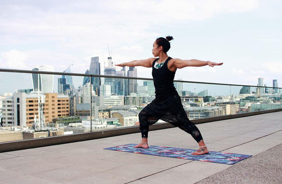 human woman standing on mat raising hands people