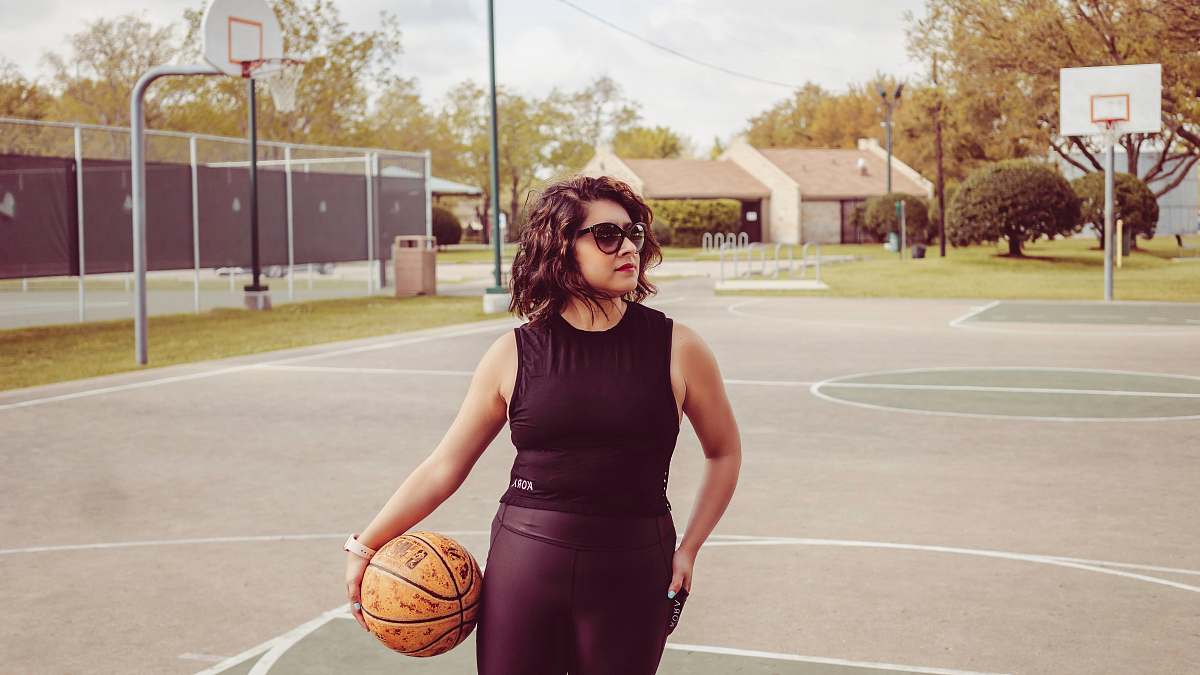 human woman standing outdoors holding basketball people