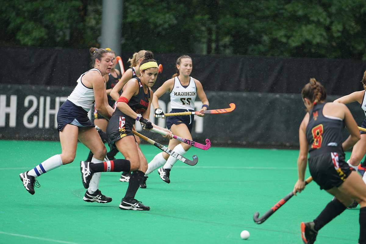 human women playing field hockey people