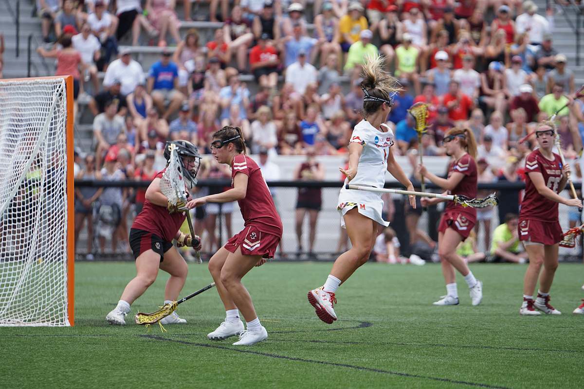 human women playing lacrosse at the open field apparel