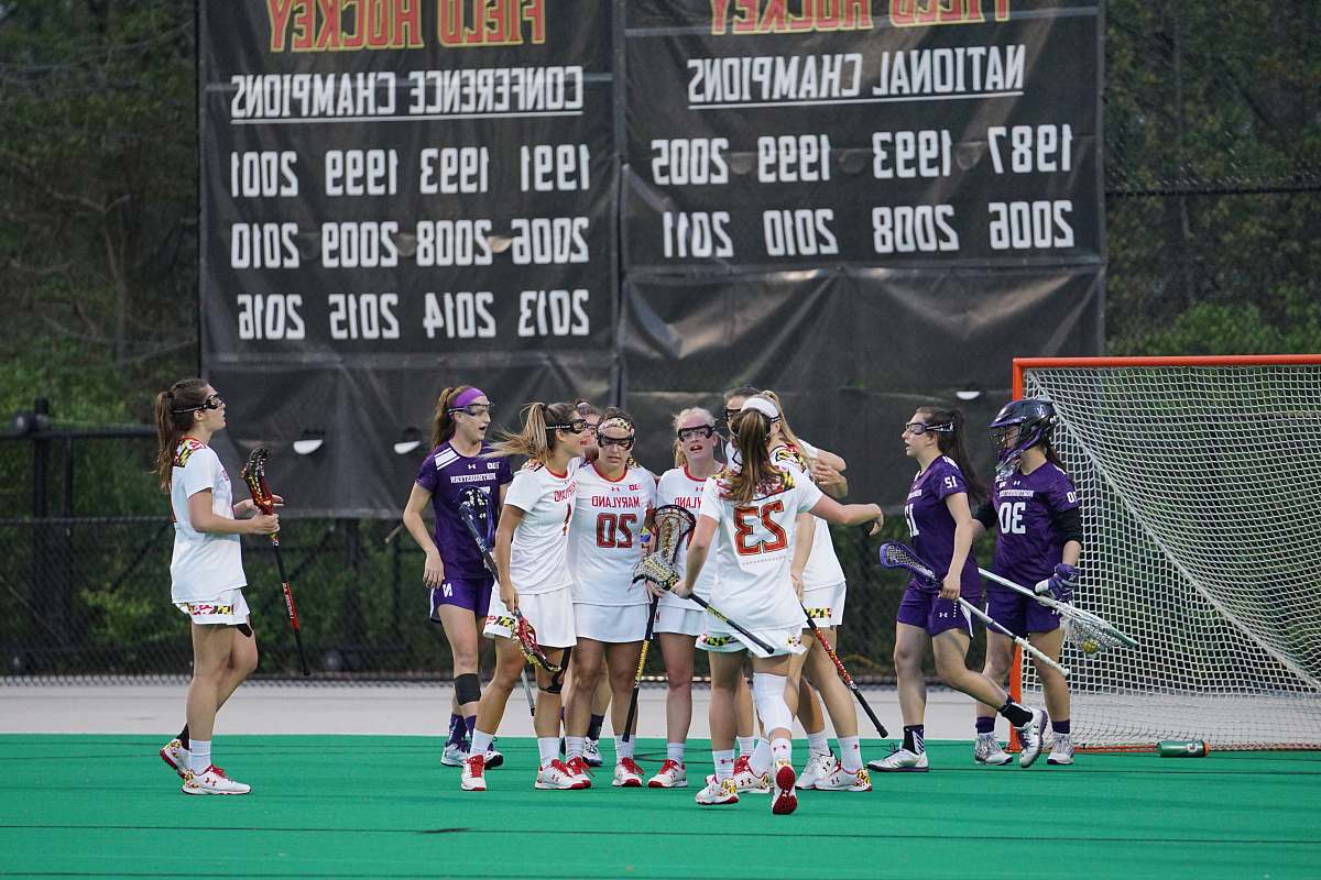 human women playing lacrosse during daytime people