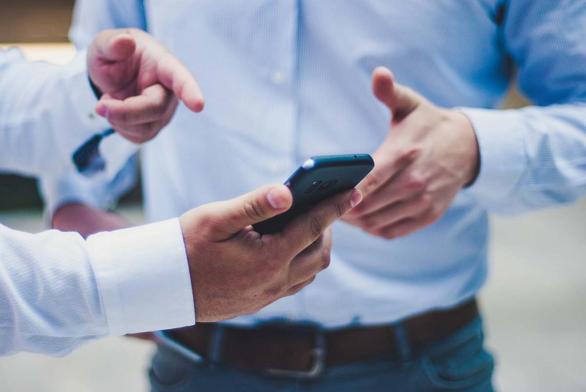electronics person holding black smartphone cell phone