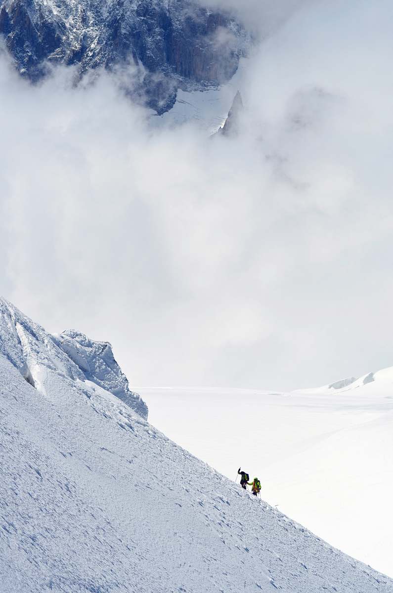 mountain two person hiking on snow-capped mountain mont blanc