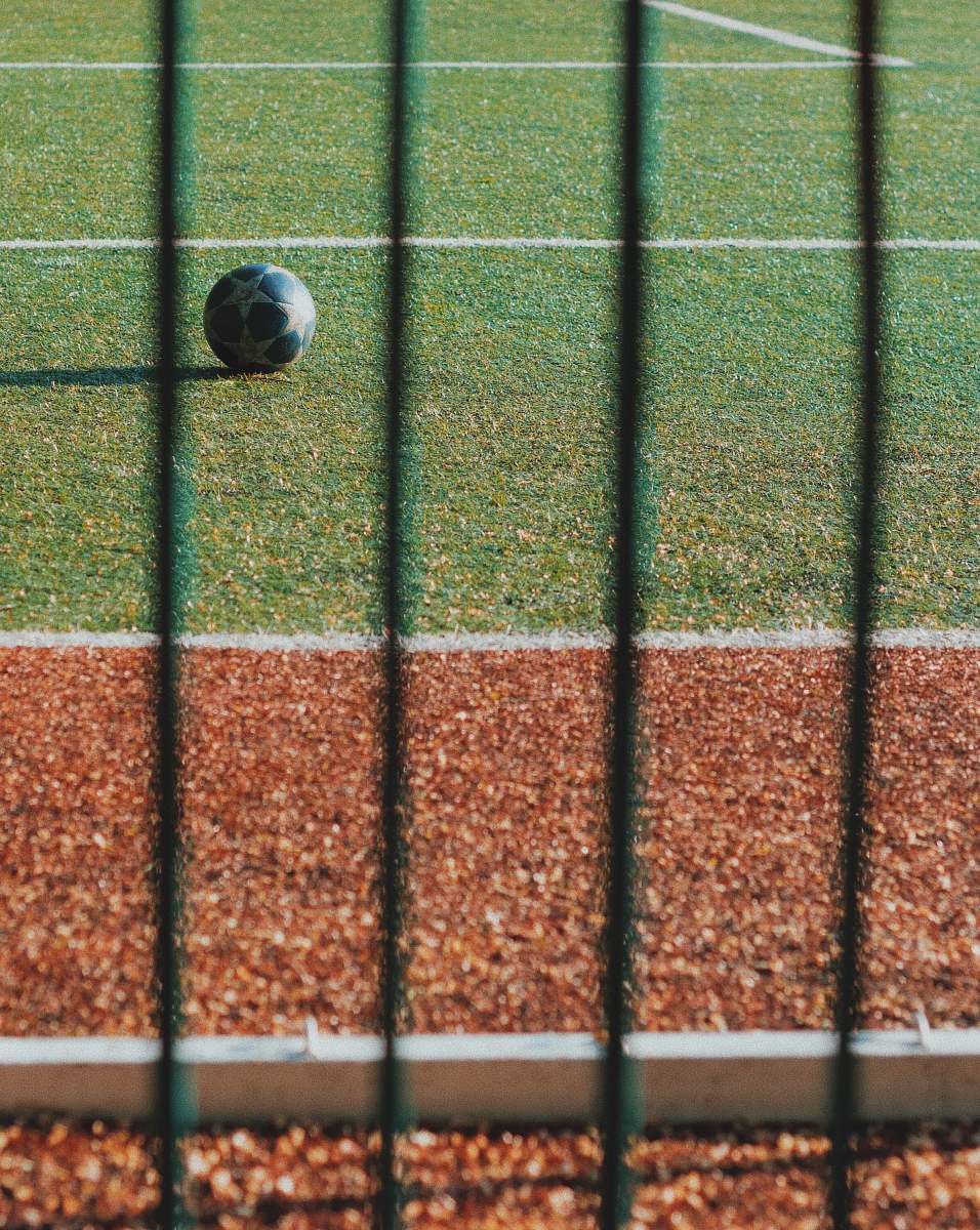 ball black soccer ball on green grass field asphalt